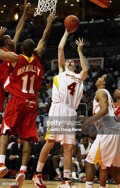 Ryan Kelly of the East Team shoots over Avery Bradley Jr. #11 of the West Team in the 2009 McDonald's All American Men's High School Basketball Game...