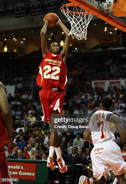 John Henson of the West Team dunks over Dexter Strickland of the East Team in the 2009 McDonald's All American Men's High School Basketball Game at...