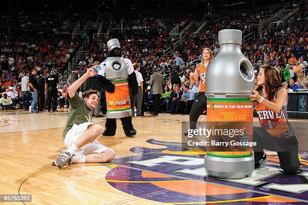 Suns fan competes in a timeout competition featuring the team's new "Green is the New Orange" slogan as the Phoenix Suns host the Houston Rockets in...