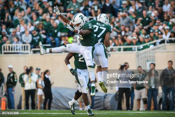 Spartans linebacker Andrew Dowell and safety Khari Willis celebrate an important first half stop during a Big Ten Conference NCAA football game...