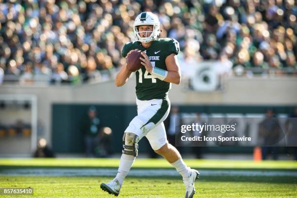 Spartans quarterback Brian Lewerke rolls out to pass during a Big Ten Conference NCAA football game between Michigan State and Iowa on September 30...