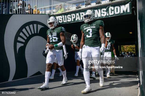 Spartans wide receiver Darrell Stewart Jr. And running back L.J. Scott take the field for warm-ups prior to a Big Ten Conference NCAA football game...