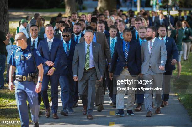 Spartans head coach Mark Dantonio leads his team on a walk from the hotel to the stadium prior to a Big Ten Conference NCAA football game between...