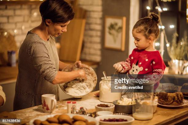everyone loves christmas baking - kids cooking christmas stock pictures, royalty-free photos & images