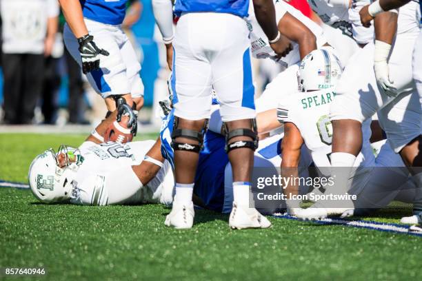 Eastern Michigan defensive lineman Dion Dawson comes up with the fumble recovery during a regular season college football game between the Eastern...