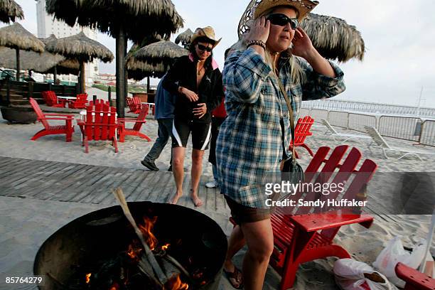 Carol Arthur and Tammy Delu, from Seattle, relax at a bar along the beach April 1, 2009 in Rosarito, Mexico. The tourist industry in some northern...
