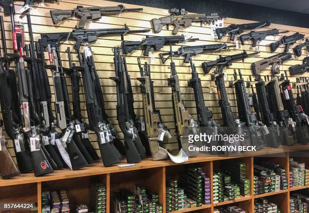 Semi-automatic rifles are seen for sale in a gun shop in Las Vegas, Nevada on October 4, 2017. Mass killer Stephen Paddock used semi-automatic...