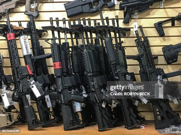 Semi-automatic rifles are seen for sale in a gun shop in Las Vegas, Nevada on October 4, 2017. Mass killer Stephen Paddock used semi-automatic...