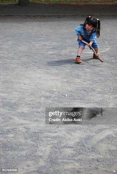 a girl drawing on ground. - kid stock stock-fotos und bilder