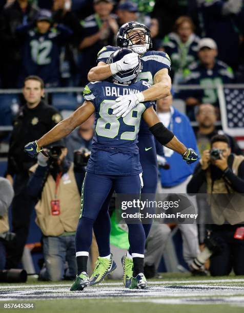 Luke Willson of the Seattle Seahawks celebrates a touchdown with teammate Doug Baldwin against the Indianapolis Colts at CenturyLink Field on October...