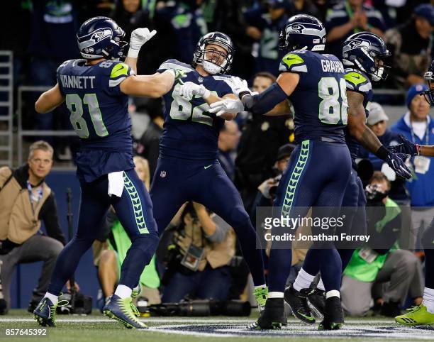 Luke Willson of the Seattle Seahawks celebrates a touchdown with teammates Nick Vannett and Jimmy Graham against the Indianapolis Colts at...