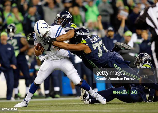 Jacoby Brissett of the Indianapolis Colts is sacked by MIchael Bennett and Bobby Wagner of the Seattle Seahawks at CenturyLink Field on October 1,...