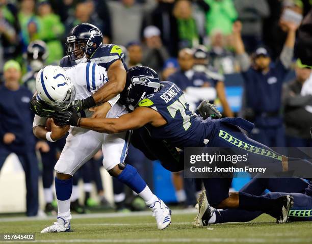 Jacoby Brissett of the Indianapolis Colts is sacked by MIchael Bennett and Bobby Wagner of the Seattle Seahawks at CenturyLink Field on October 1,...