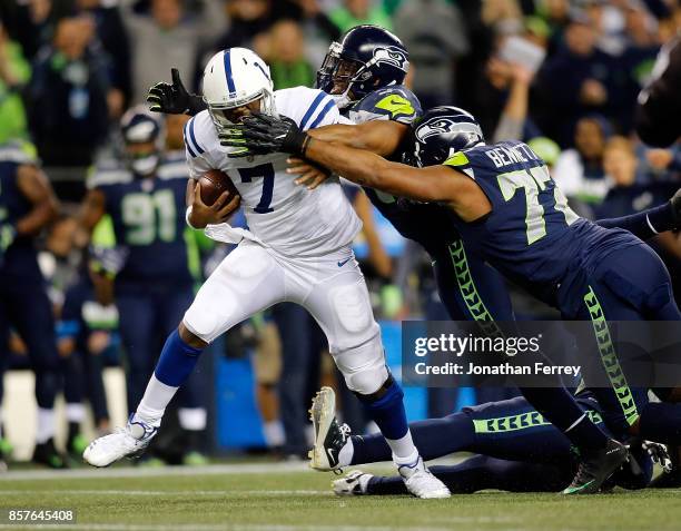 Jacoby Brissett of the Indianapolis Colts is sacked by MIchael Bennett and Bobby Wagner of the Seattle Seahawks at CenturyLink Field on October 1,...