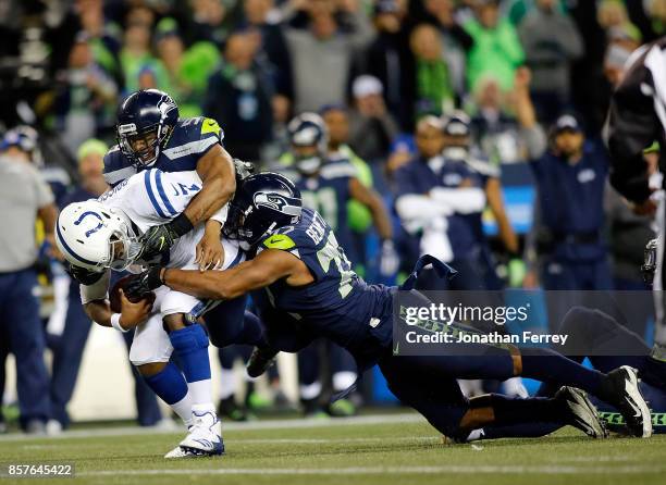 Jacoby Brissett of the Indianapolis Colts is sacked by MIchael Bennett and Bobby Wagner of the Seattle Seahawks at CenturyLink Field on October 1,...