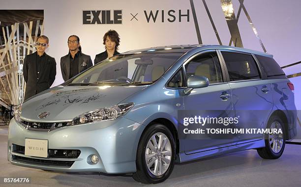 Japanese pop group Exile members, Atsushi, Hiro and Takahiro, pose beside Toyota Motors' new "Wish" compact mini van during its press preview in...