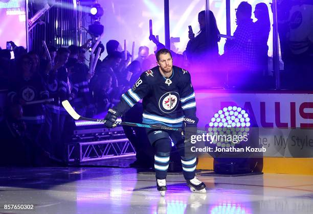 Bryan Little of the Winnipeg Jets hits the ice for the player introductions prior to puck drop in the home opener against the Toronto Maple Leafs at...