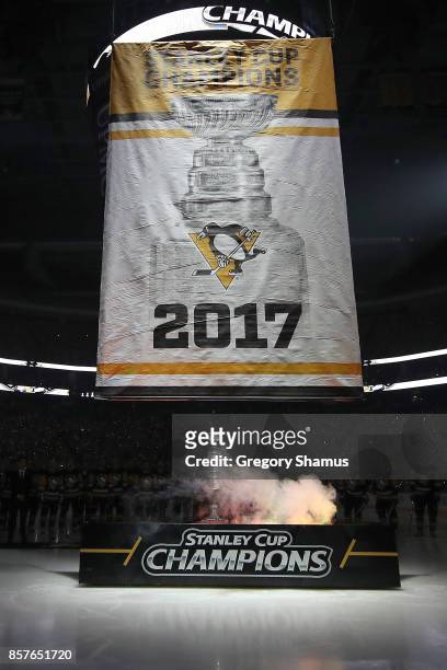 The Pittsburgh Penguins raise their 2017 Stanley Cup Championship banner prior to a game agains the St. Louis Blues at PPG PAINTS Arena on October 4,...