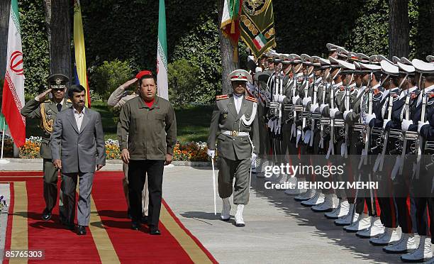 Iranian President Mahmoud Ahmadinejad reviews the honour guard with his Venezuelan counterpart Hugo Chavez during a welcoming ceremony in Tehran on...