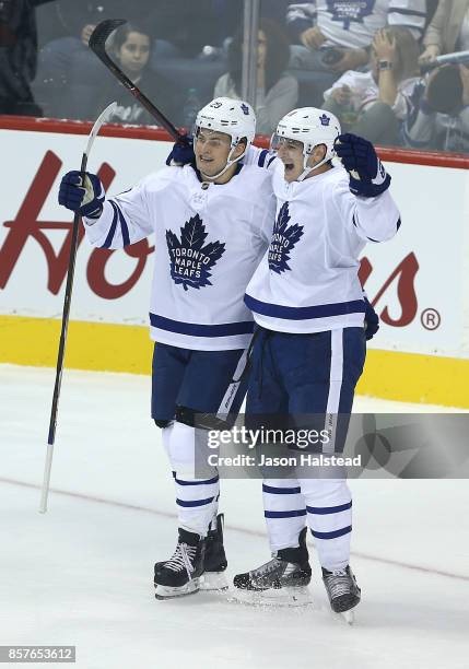 Forward William Nylander and forward Zach Hyman of the of the Toronto Maple Leafs celebrate Nylander's goal against the Winnipeg Jets during NHL...