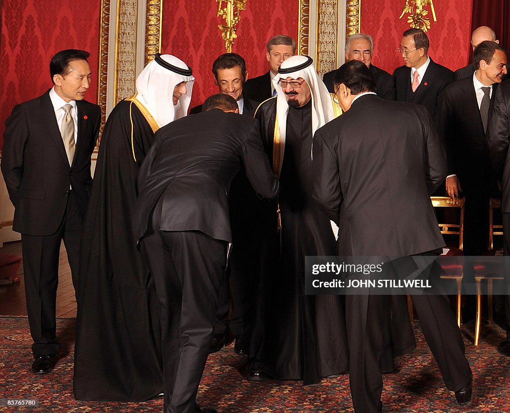 US President Barack Obama (3rd L) bows t