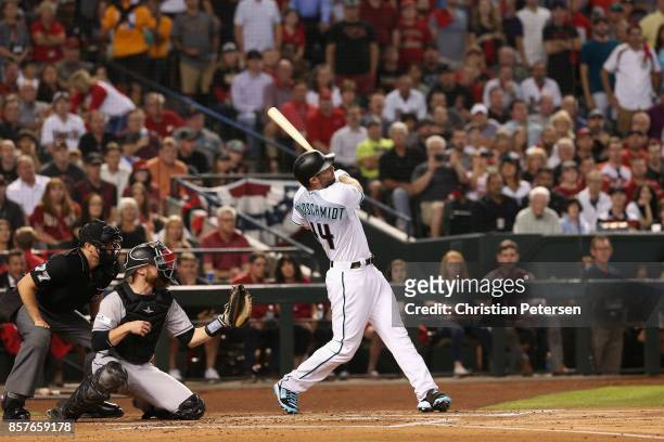 Paul Goldschmidt of the Arizona Diamondbacks hits a three-run home run during the bottom of the first inning of the National League Wild Card game...