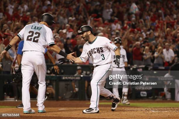 Daniel Descalso of the Arizona Diamondbacks reacts with teammate Jake Lamb after hitting a two run home run during the bottom of the third inning...