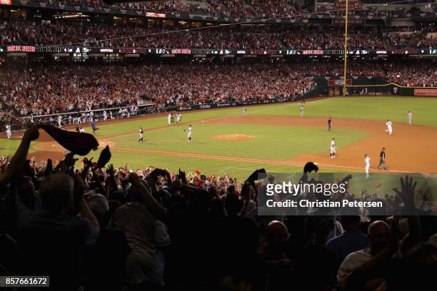 Arizona Diamondbacks fans react after a three-run home run by Paul Goldschmidt during the bottom of the first inning of the National League Wild Card...