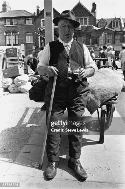 Man leaning against a handcart in the East End of London, 1960s.