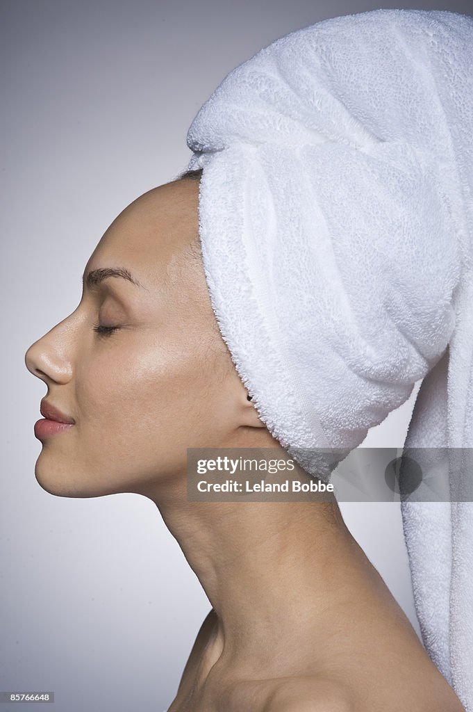 Profile of woman with hair wrapped in a towel