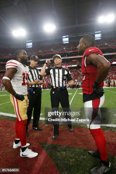 Official Tony Corrente tosses the coin prior to the start of overtime between the San Francisco 49ers and the Arizona Cardinals at the University of...