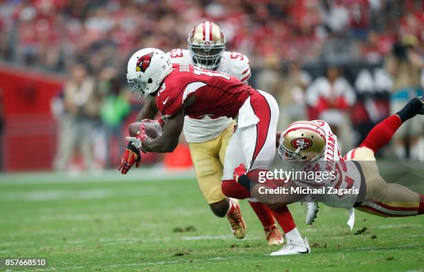 Waun Williams of the San Francisco 49ers tackles Jaron Brown of the Arizona Cardinals during the game at the University of Phoenix Stadium on October...