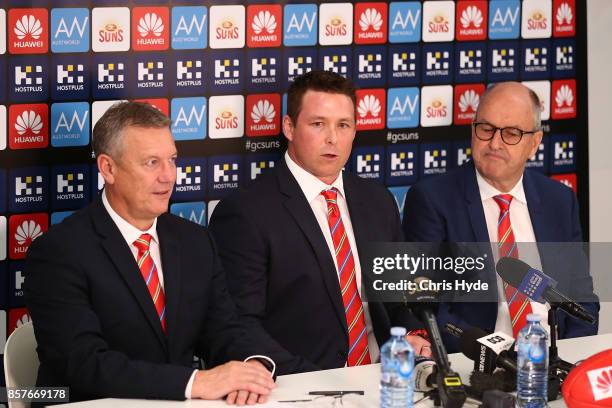 Mark Evans, Senior Coach Stuart Dew and Chairman Tony Cochrane speak to the media during a Gold Coast Suns AFL press conference at their training...