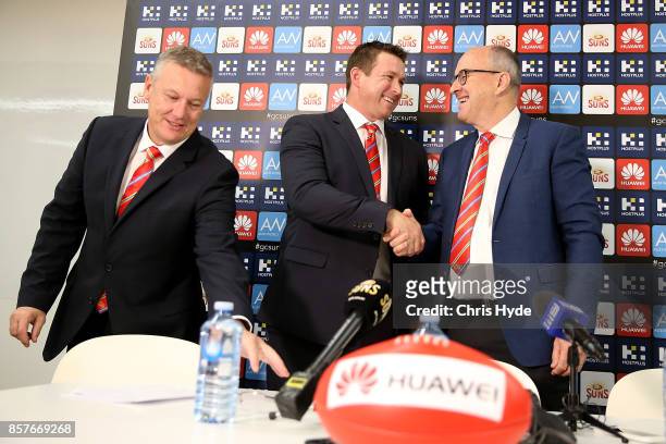 Senior Coach Stuart Dew and Chairman Tony Cochrane shake hands during a Gold Coast Suns AFL press conference at their training facility on October 5,...