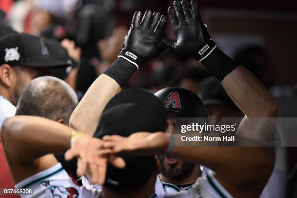 Daniel Descalso of the Arizona Diamondbacks reacts with teammate Yasmany Tomas after hitting a two run home run during the bottom of the third inning...