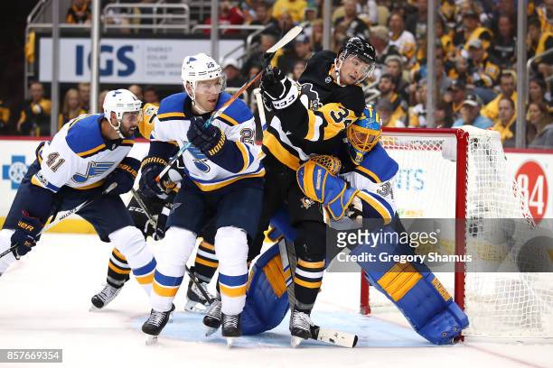 Tom Kuhnhackl of the Pittsburgh Penguins tries to find the puck between Jake Allen and Paul Stastny of the St. Louis Blues during the second period...