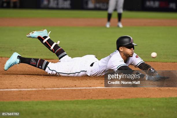 Ketel Marte of the Arizona Diamondbacks slides into third base during the bottom of the second inning of the National League Wild Card game against...