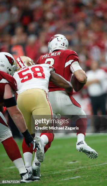 Elvis Dumervil of the San Francisco 49ers sacks Carson Palmer of the Arizona Cardinals for his 100th career sack during the game at the University of...