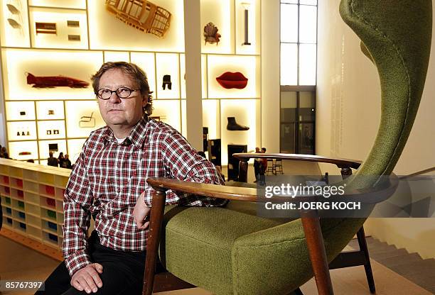 Lars Dafnaes, leader of the design department at Swedish flat pack furniture company IKEA, poses next to a "Cavelli" armchair produced in 1959 by...