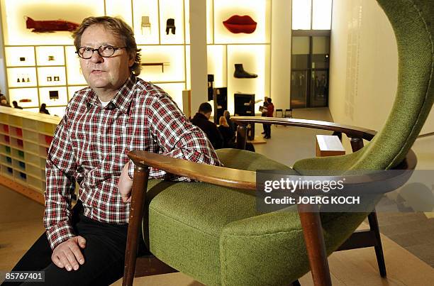 Lars Dafnaes, leader of the design department at Swedish flat pack furniture company IKEA, poses next to a "Cavelli" armchair produced in 1959 by...