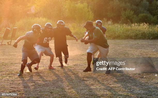 Picture taken on August 19 shows players of the Patriots American football team taking part in a training session in the small town of...