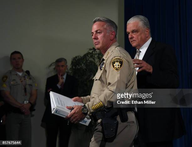 Clark County Sheriff Joe Lombardo and Clark County Commission Chairman Steve Sisolak pause as they leave a news conference at the Las Vegas...