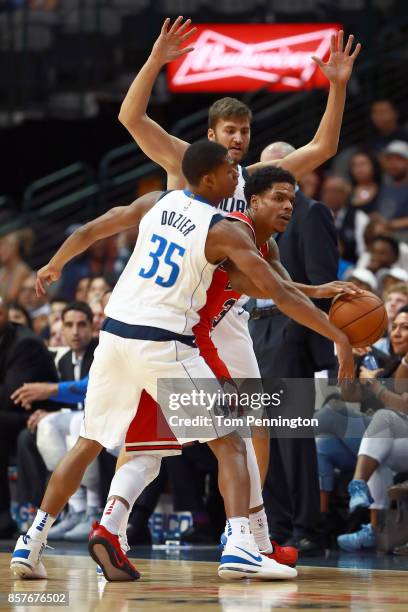 Jarell Eddie of the Chicago Bulls controls the ball against PJ Dozier of the Dallas Mavericks and Maximilian Kleber of the Dallas Mavericks in the...