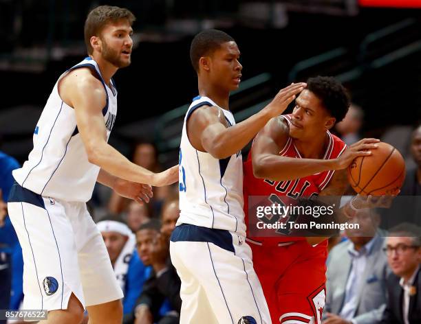 Jarell Eddie of the Chicago Bulls controls the ball against PJ Dozier of the Dallas Mavericks and Maximilian Kleber of the Dallas Mavericks in the...