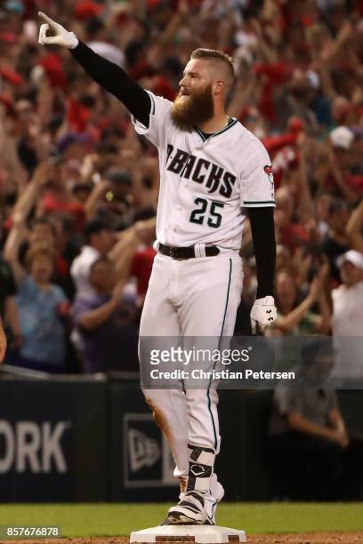 Archie Bradley of the Arizona Diamondbacks reacts after hitting aN RBI triple during the bottom of the seventh inning of the National League Wild...