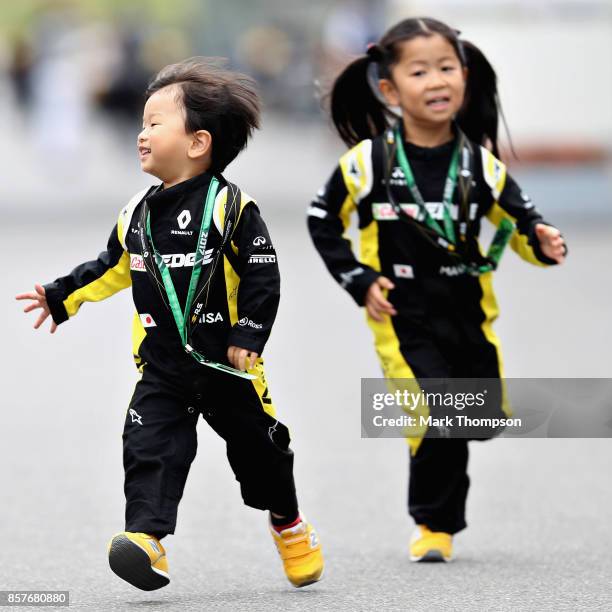 Pair of young fans run around in the Paddock during previews ahead of the Formula One Grand Prix of Japan at Suzuka Circuit on October 5, 2017 in...