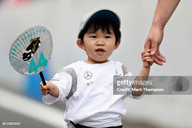 Young Lewis Hamilton of Great Britain and Mercedes GP fan during previews ahead of the Formula One Grand Prix of Japan at Suzuka Circuit on October...