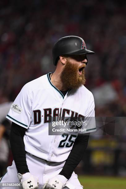 Archie Bradley of the Arizona Diamondbacks reacts after hitting a RBI triple during the bottom of the seventh inning of the National League Wild Card...