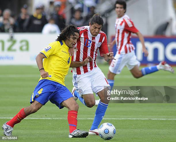 Ecuador's Paul Ambrossi vies for the ball with Paraguay's Enrique Vera during their 2010 FIFA World Cup Qualifier at the Atahualpa Stadium on April...