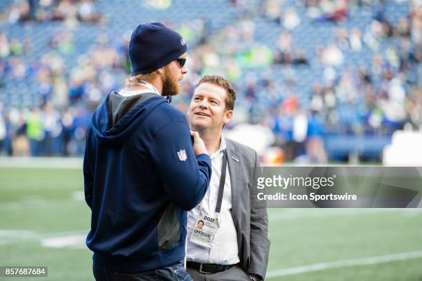 Seattle Seahawks General Manager John Schneider talks to USC snapper Jake Olson before a game between the Seattle Seahawks and the Indianapolis Colts...